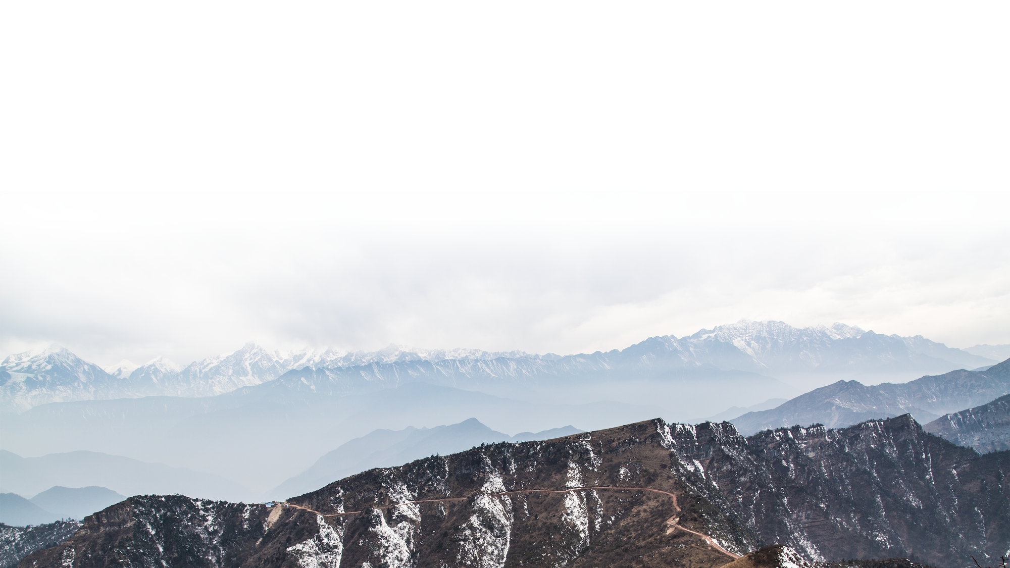 Snow-covered mountain ridges stretching across the horizon