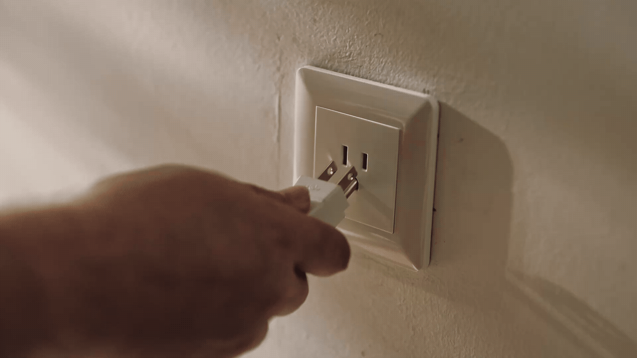 A power cord being plugged into a wall outlet for simple Sierro setup
